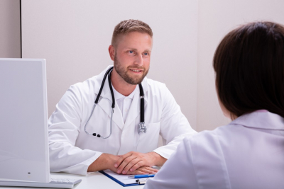 smiling doctor talking to his patient