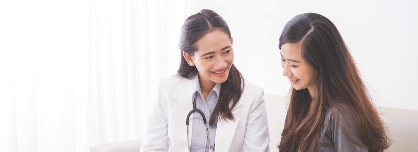 asian female doctor visiting to her patient